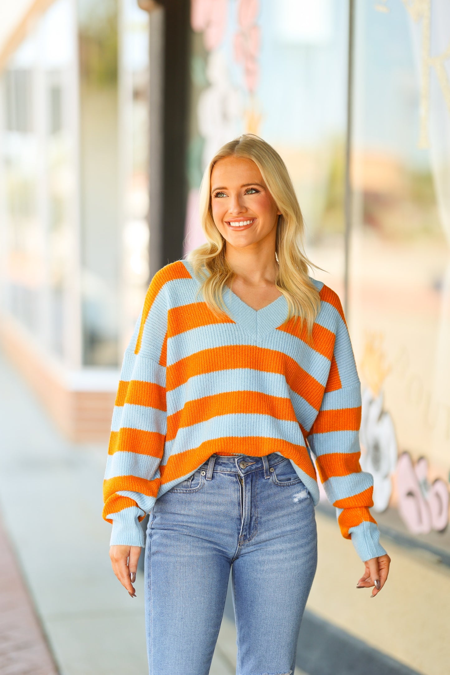 orange and blue v-neck sweater