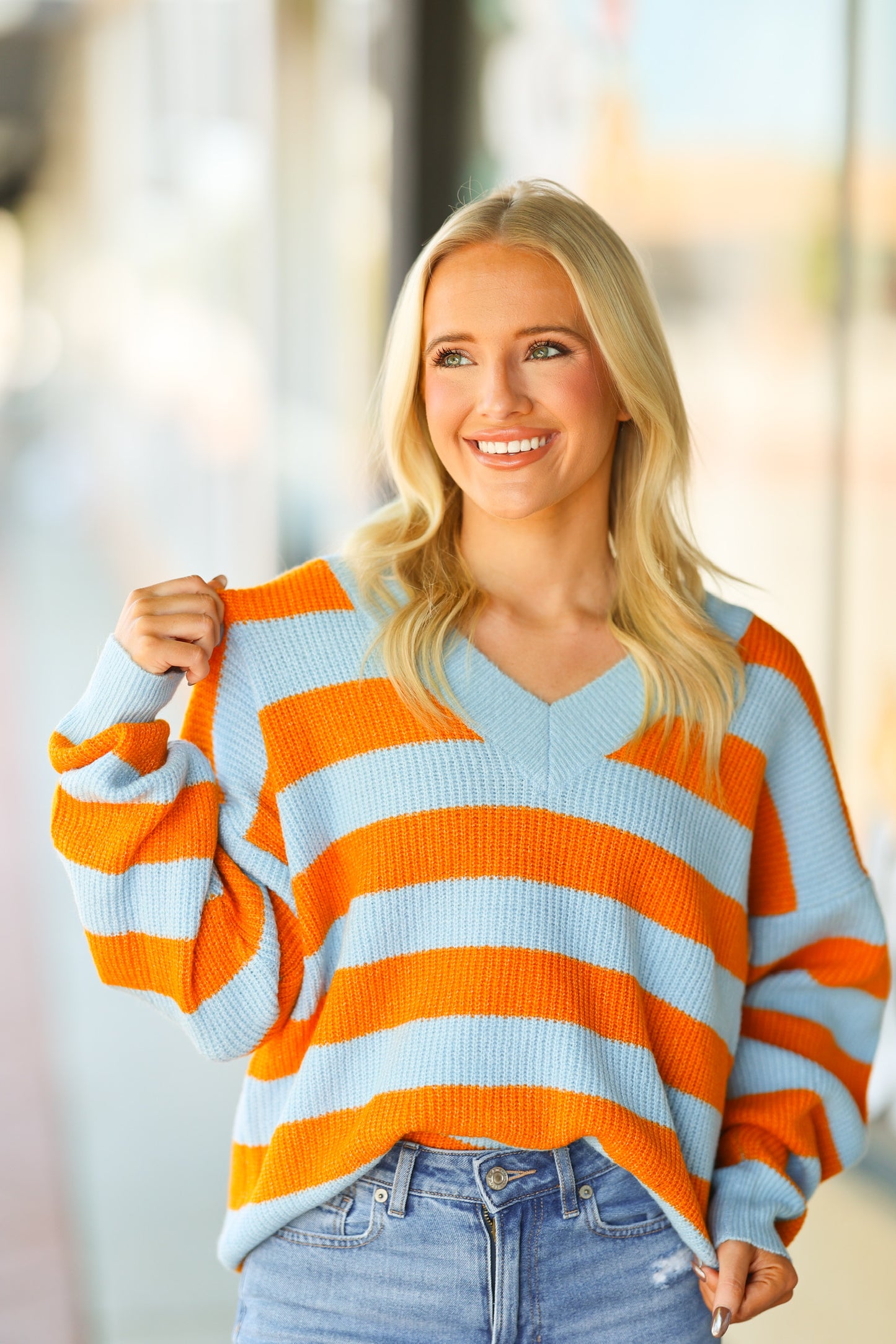 orange and blue v-neck sweater