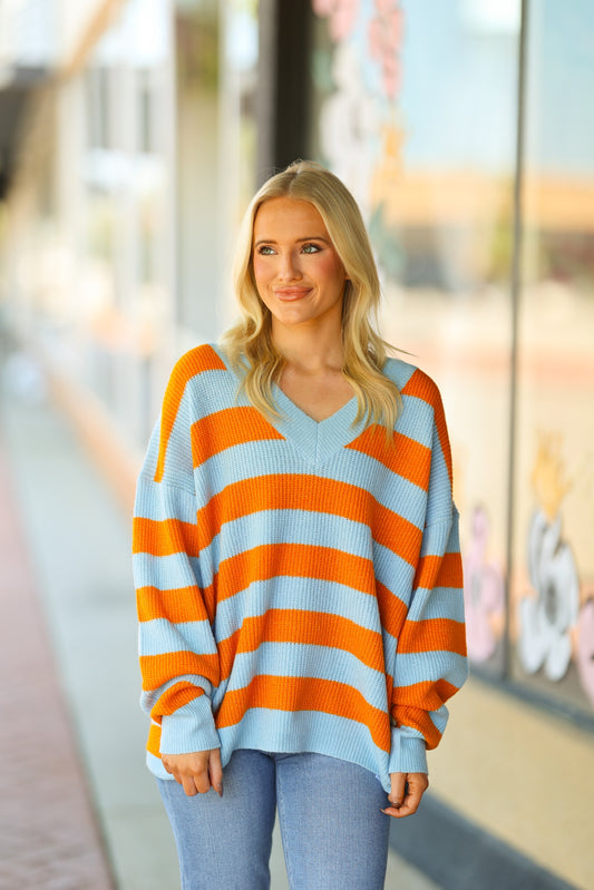 orange and blue v-neck sweater