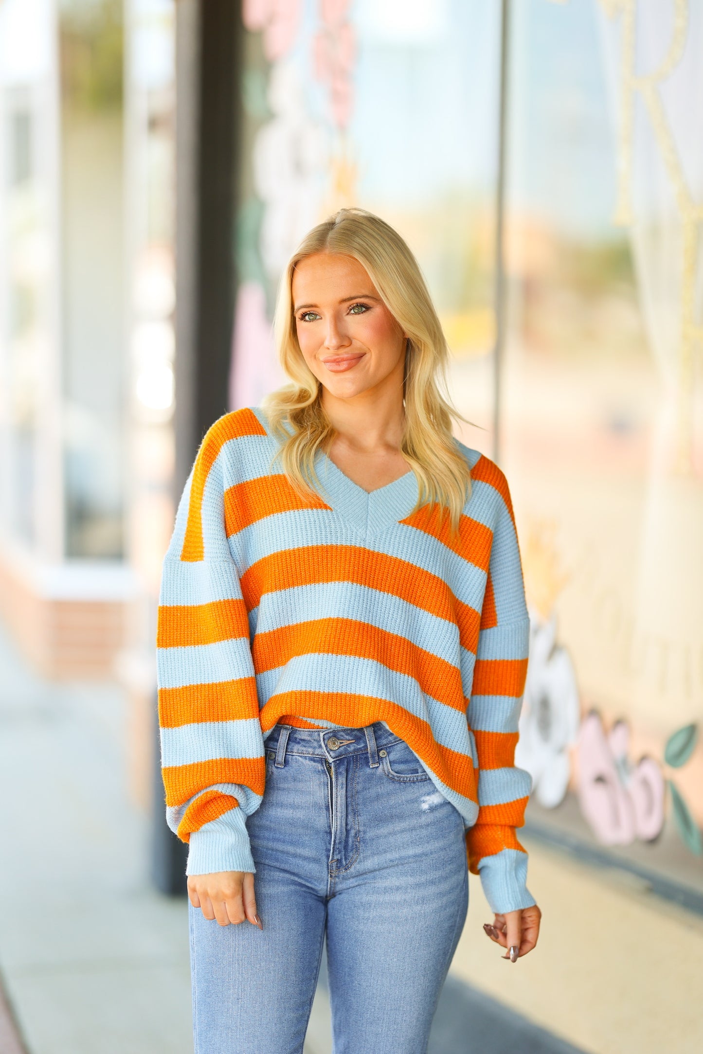 orange and blue v-neck sweater